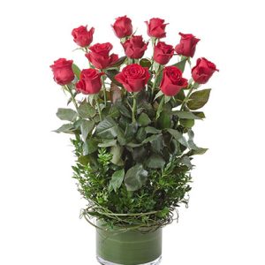 12 beautiful roses in a glass cylinda vase